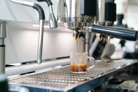 Preparing coffee in coffee shop with professional coffee machineの写真素材