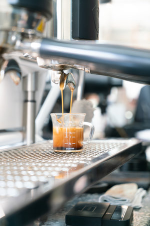 Preparing coffee in coffee shop with professional coffee machineの写真素材