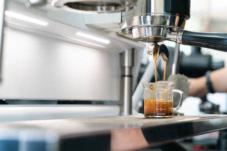 Preparing coffee in coffee shop with professional coffee machineの写真素材