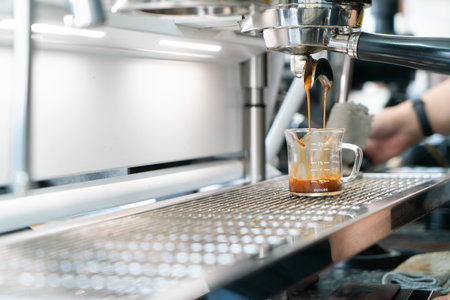 Preparing coffee in coffee shop with professional coffee machineの写真素材