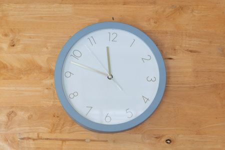 Clock placed in middle of wooden wallの写真素材