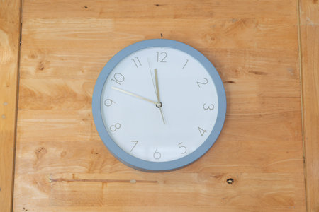 Clock placed in middle of wooden wallの写真素材