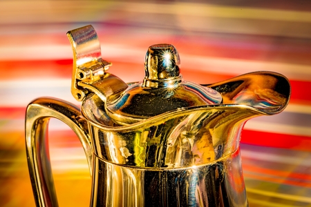 Shiny coffee pot in front of colorful backgroundの写真素材