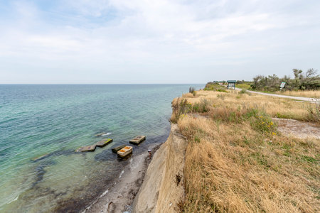 German Baltic Sea coast with sand dunes, grass, water and blue sky