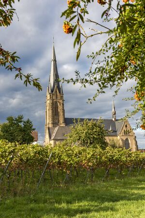 Catholic Church Edenkoben Germany Rhineland Palatinate with fountain and cloudy blue skyの写真素材