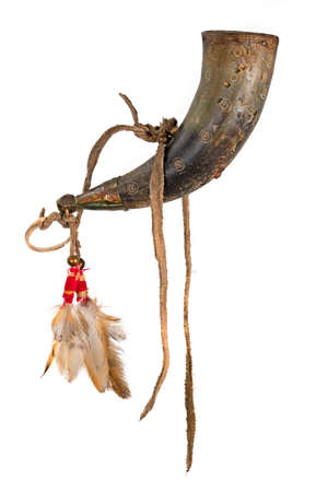 Old powder horn of the North American Indians made of horn decorated with deerskin and feathersの写真素材