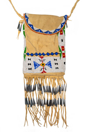 Bag of the North American Indians. Made from deerskin embroidered with colorful glass beads and leather cords isolated on whiteの写真素材