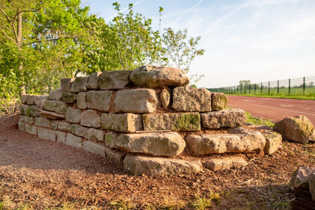 self-built wall made of natural sandstone as a biotope for insectsの写真素材