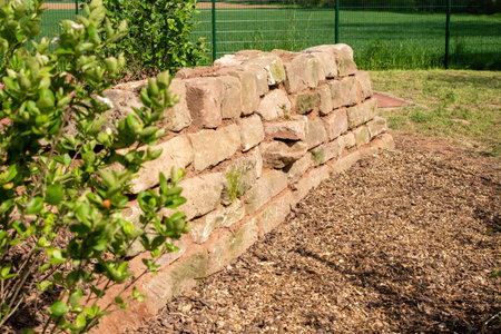 self-built wall made of natural sandstone as a biotope for insectsの写真素材