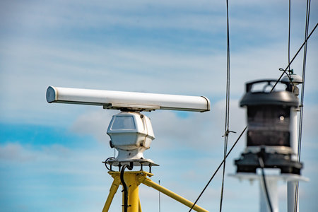Surveillance camera on the roof of a fishing boat with blue skyの写真素材