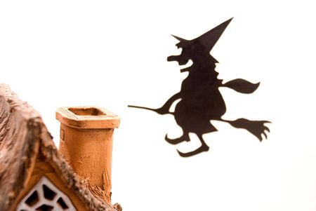 Witch,flying on broom on house,on white backgroundの写真素材