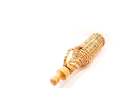 Wicker bottle on a white backgroundの写真素材
