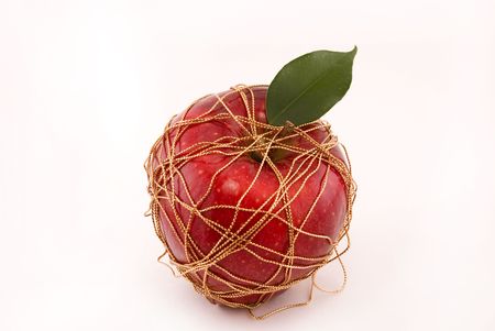 	 apple wrapped gold thread, on a white backgroundの写真素材