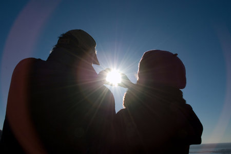 	 a man and a woman holding the sun