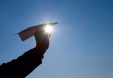 paper airplane in his handの写真素材