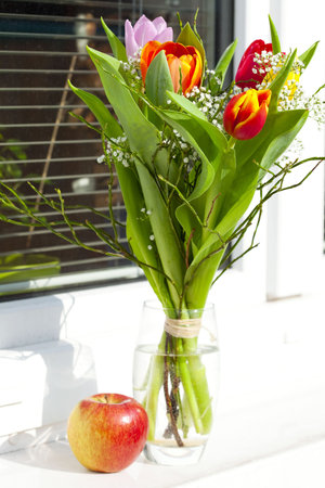 spring bouquet with tulips and an appleの写真素材