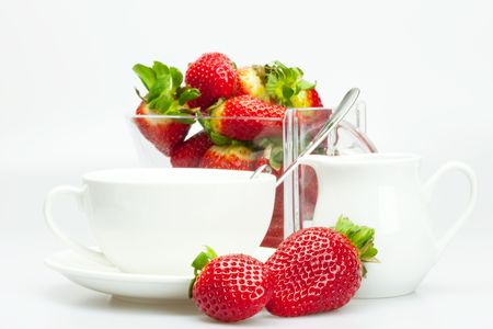 strawberry, white cup and teapot isolated on whiteの写真素材