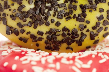 Donut with chocolate and colorful sprinkles, isolated on whiteの写真素材