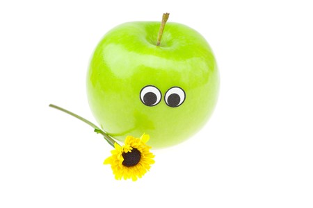 apple with eyes and a flower isolated on whiteの写真素材
