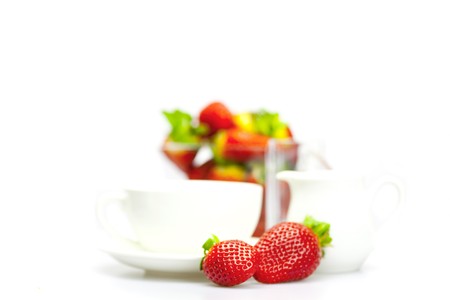 cup and strawberry in a glass bowl isolated on whiteの写真素材