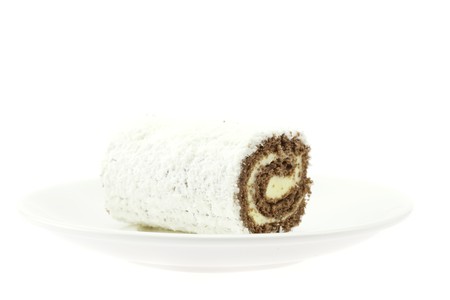 cake roll on a plate isolated on whiteの写真素材