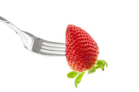 Strawberry on fork isolated on whiteの写真素材
