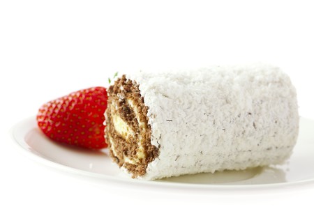 Roll cake and strawberries on a plateの写真素材