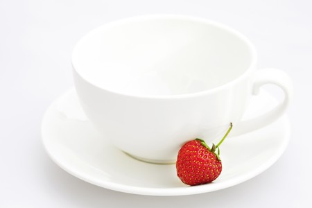 cup saucer and strawberries isolated on whiteの写真素材