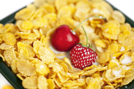 background of  bowl of cornflakes milk  cherry  and strawberry  