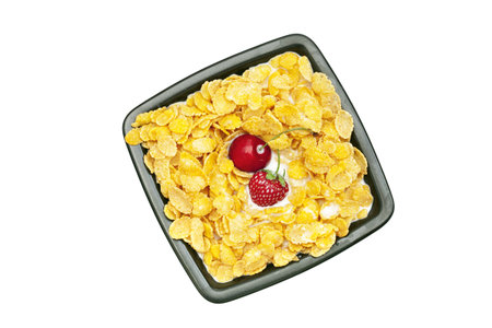 bowl of cornflakes milk  cherry  and strawberry  isolated on white