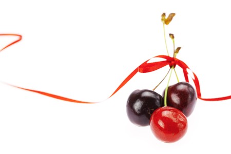 cherry with ribbon isolated on whiteの写真素材