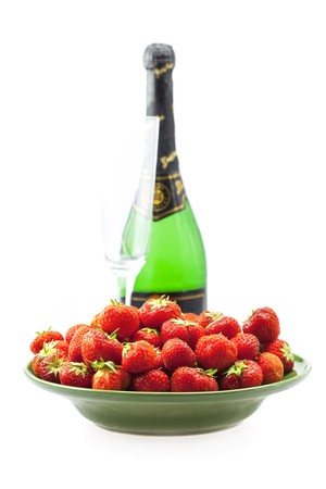 Champagne glass and strawberries isolated on whiteの写真素材