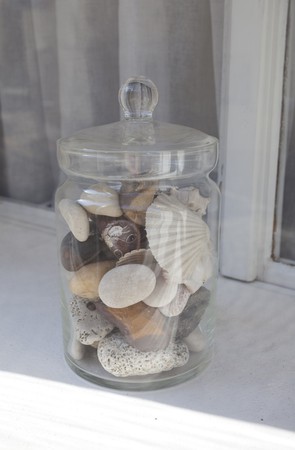 Bank of stones and shells on the windowsillの写真素材