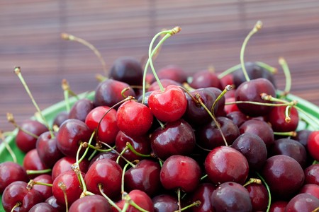 cherry in plate on a bamboo matの写真素材