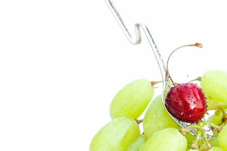 cup of grapes and cherries  isolated on whiteの写真素材