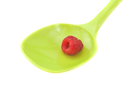 raspberries in a spoon isolated on whiteの写真素材