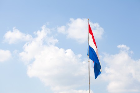 Dutch flag against the blue skyの写真素材