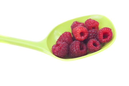 Raspberries in a spoon isolated on whiteの写真素材