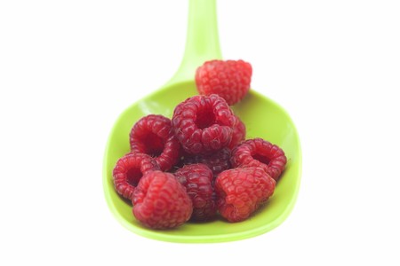 Raspberries in a spoon isolated on whiteの写真素材