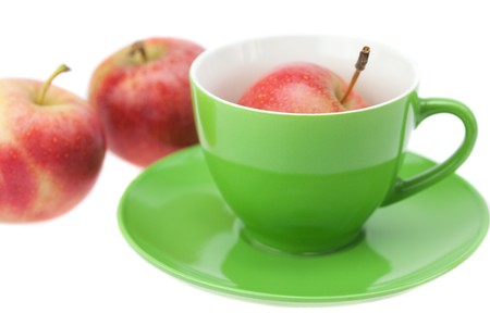 cup, saucer and apples isolated on whiteの写真素材