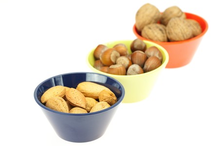 nuts in bowls isolated on whiteの写真素材
