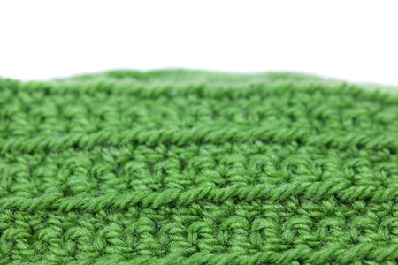 Skein of wool  and knitted piece isolated on whiteの写真素材
