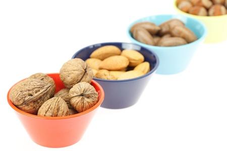 nuts in bowls isolated on whiteの写真素材