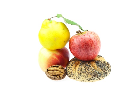 loaf with poppy seeds, quince, apples and walnuts isolated on whiteの写真素材