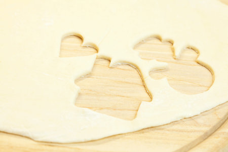 cut in the dough snowman, heart, and  house