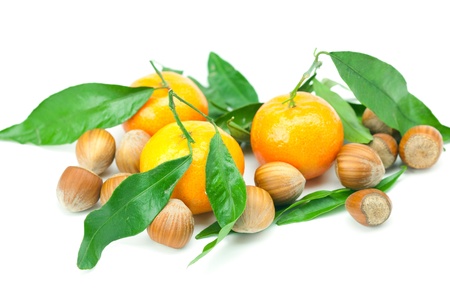 mandarin with green leaves and nuts  isolated on whiteの写真素材