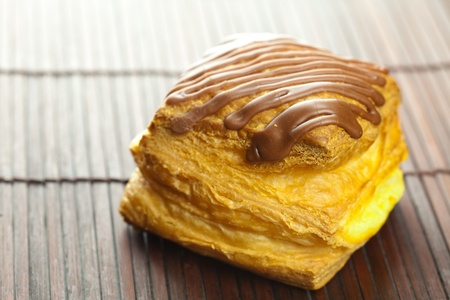 cake with chocolate lying on a bamboo matの写真素材