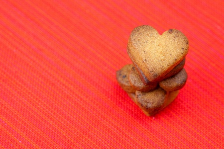  cookie  in the form of heart  in a plate  on a red backgroundの写真素材