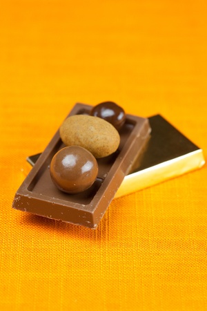 chocolate bars and candy on the orange fabricの写真素材
