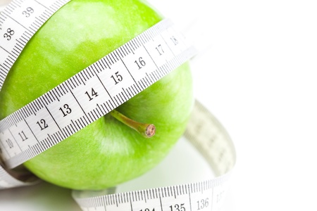 apple and measure tape isolated on whiteの写真素材